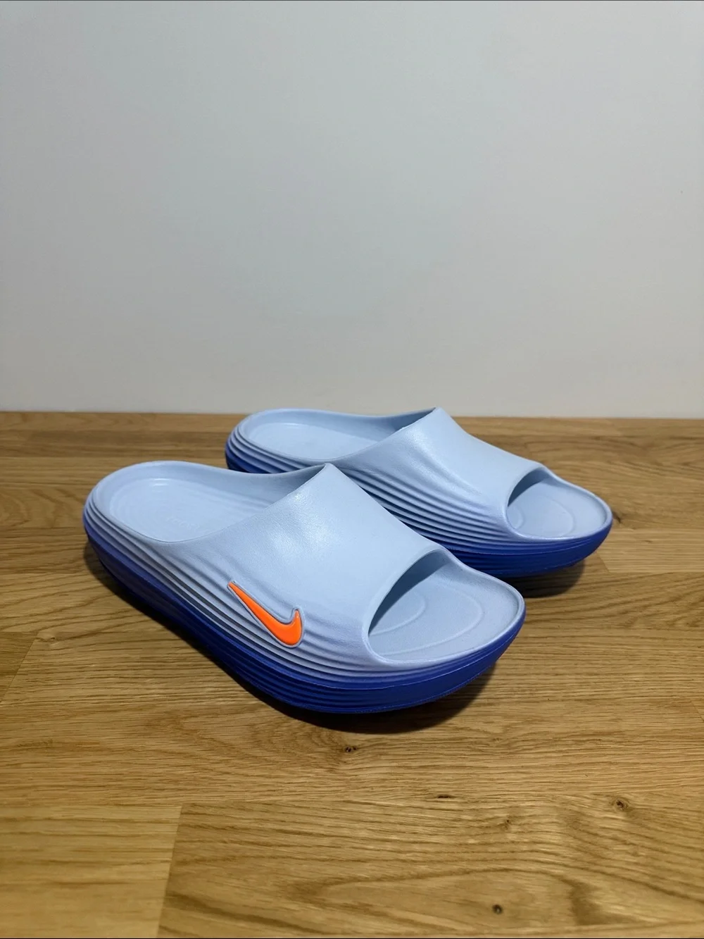 Brand new men’s size 9 Nike Rejuven8 Light Blue Slide Sandals with Orange Swoosh